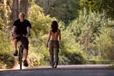 topless-girl-walking-by-man-on-bike-smiling.jpg