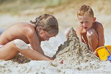 children-building-sand-castle-beach-17207422.jpg