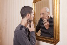 34882270-young-man-looking-at-an-older-himself-in-the-mirror.jpg