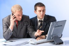 1963756-two-young-attractive-business-men-working-in-office.jpg