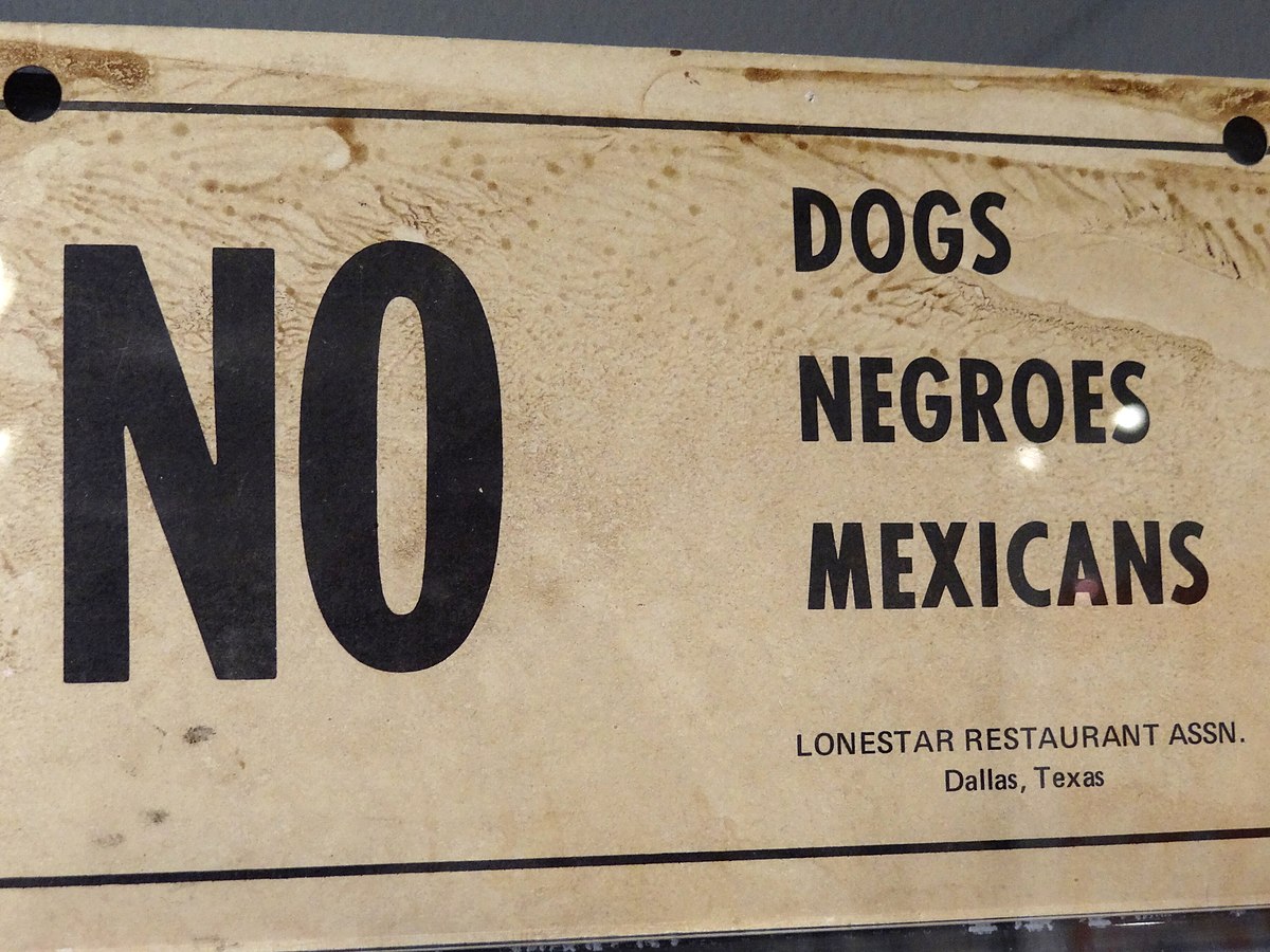 1200px-No_Dogs-Negroes-Mexicans_-_Racist_Sign_from_Deep_South_-_National_Civil_Rights_Museum_-_Downtown_Memphis_-_Tennessee_-_USA.jpg