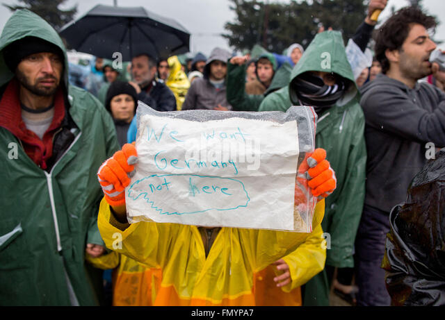 idomeni-greece-13th-mar-2016-a-refugee-holds-up-a-sign-written-with-fmypa7.jpg